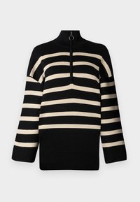Suéter de punto a rayas en negro y beige con cuello alto y cierre de medio cremallera. Presenta mangas largas y un ajuste holgado.