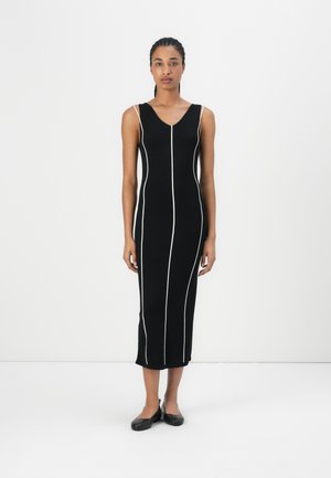 Black sleeveless dress with white vertical stripes, v-neckline, fitted design, knee-length, made from a smooth fabric. Accents include contrasting stitching.