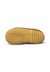 Sole of a shoe with a textured rubber surface, featuring a wavy pattern and small raised dots. Color is light tan with a dark edge.