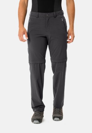 Pantalons de randonnée gris à zip détachable fabriqués dans un tissu léger et respirant. Comprend des poches latérales zippées et des poignets ajustables. Inclut des jambes inférieures amovibles.