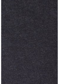 Textured dark navy fabric with a fine woven pattern, displaying subtle variations in color. The surface appears smooth and dense.
