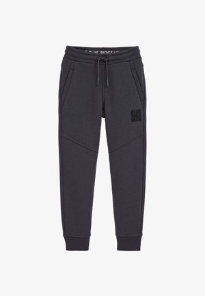 Tumši pelēki sporta bikses, kas izgatavotas no mīksta kokvilnas maisījuma. Tām ir elastīgs jostasvētks ar auklu, sānu kabatas un drukāts logo uz augšstilba.