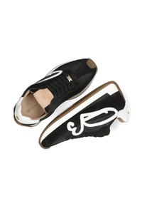 Czarno-białe sneakersy wykonane z zamszu i skóry, z charakterystycznym białym logo, czarnymi sznurówkami i podeszwą z gumy.