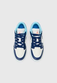 White and navy leather sneakers with blue accents, perforated toe, flat laces, and a visible logo on the tongue. Textured sole.