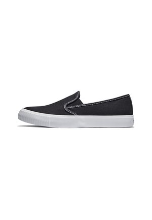 Sort slip-on lærredssko med hvid gummisål og hvide syninger langs de øverste kanter, vist fra siden på en hvid baggrund.