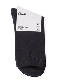 Calcetines negros de tobillo con una textura suave y un puño acanalado. La etiqueta del producto es visible, indicando la marca "Etam" y la talla "TU."