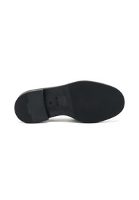 Suola in gomma nera con pattern di grip testurizzato e una forma leggermente curvata; presenta marchi e indicazioni di taglia sul tallone.