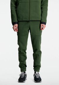 New Balance R W TECH - Pantaloni sportivi - kombu