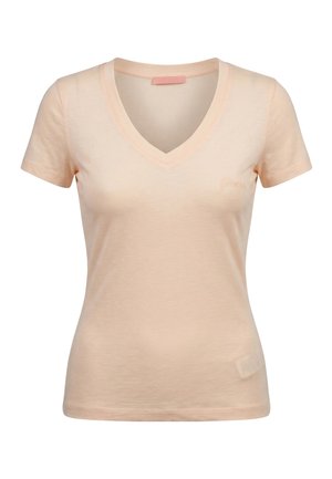 T-shirt da donna color pesca chiaro a maniche corte con scollo a V, logo ricamato discreto sul petto sinistro e silhouette leggermente aderente.