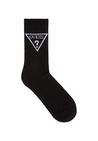 Calzino nero con texture a coste, decorato con un logo triangolare bianco contenente la scritta "GUESS" e un punto interrogativo. Design classico, stile alla caviglia.