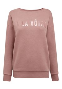 Lyserød sweatshirt med afslappet pasform, med teksten "À LA VÔTRE" i et skinnende, reflekterende materiale på tværs af brystet og ribstrikkede manchetter.