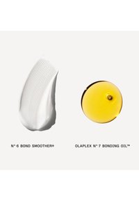 Tache de crème blanche étiquetée N°6 Bond Smoother à côté d'une goutte d'huile dorée étiquetée Olaplex N°7 Bonding Oil sur fond blanc.