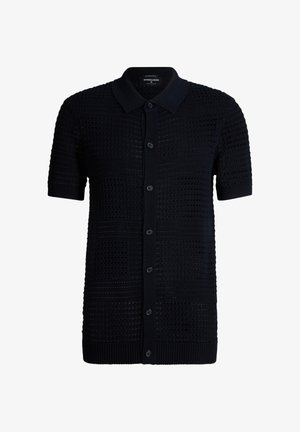 Polo noir à manches courtes en maille, avec fermeture à boutons sur le devant et motif gaufré texturé, doté d'un col et de poignets unis.