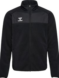Schwarze Jacke mit Reißverschluss und hohem Kragen, kontrastierendes strukturiertes Panel auf der Brust, lange Ärmel und weißes Hummel-Logo auf der linken Brustseite.