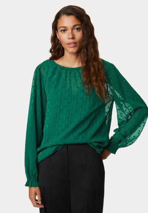 Langærmet grøn bluse lavet af letvægtsstof med lodrette striber og cirkulære mønstre. Har en samlekrave og puffede ærmer.