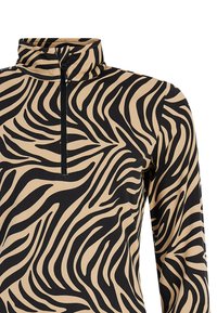 Maglietta a maniche lunghe con collo alto, caratterizzata da un motivo a strisce zebra nere e beige e una mezza cerniera sul collo. Tessuto morbido ed elastico.