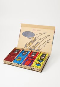 Four pairs of socks in a box featuring Marvel comic designs. Colors include red, blue, yellow, and purple, with various superhero graphics.