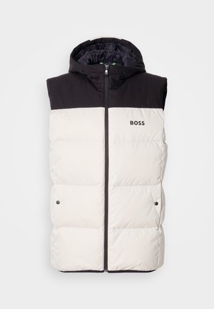 Opblaasbare vest met capuchon, met een zwarte bovenkant en een crèmekleurige onderkant, ritsluiting en een logo-detail op de voorkant.