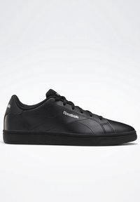Black Reebok sneakers with a smooth leather upper, round toe, flat black rubber outsole, and contrasting white logo on the side.
