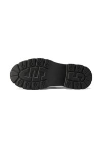 Sole di scarpa in gomma nera con profili profondi, motivi circolari e ovali, con un marchio prominente al centro e finiture testurizzate.
