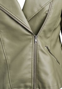 Olive green leather jacket with a diagonal zip closure, angular lapels, and a side zip pocket. Smooth texture and fitted design.