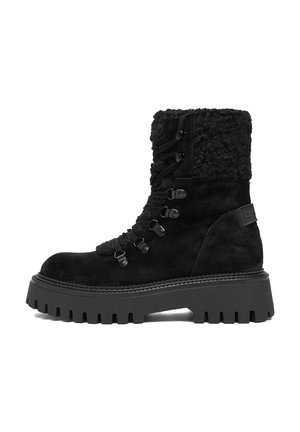 Black suede winter boot with thick tread sole, lace-up front, and fuzzy cuff around the ankle, side view on white background.