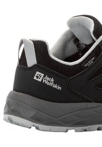 Black hiking shoe with a textured upper, grey accents, and logo. Features a padded collar and a durable rubber sole with a patterned tread.