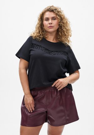 Black short-sleeve t-shirt with textured detailing featuring beaded accents, paired with burgundy faux leather shorts with an elastic waistband.