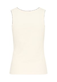 Sleeveless women's top, cream color, textured surface with faint diamond pattern, round neckline, and contrast stitching along the edges.