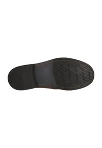 Black rubber sole with a hexagonal texture, featuring a brown leather edge and visible stitching along the perimeter.