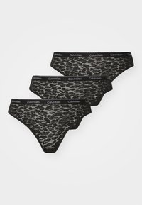 Sorte blonder truser med geometrisk mønster, med en svart elastisk midjebånd med merke. Tre deler vist.