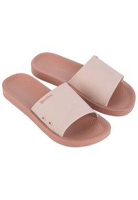 Ciabatte in gomma rosa chiaro con ampia fascia superiore, soletta testurizzata e due fori decorativi su ciascun lato. Design della suola piatta.