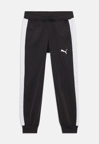 Svarta träningsbyxor med vita sidostråk, elastisk midja och Puma-logotyp. Tillverkade av ett smidigt, lätt material med ribbade muddar.