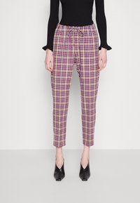 Pantalons à carreaux multicolores en beige, violet et rouge. Taille élastique avec cordon de serrage. Jambes fuselées, tissu léger.