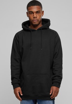 Sudadera de algodón negra con un bolsillo delantero, capucha con cordones y puños acanalados. El diseño es simple y sin adornos, proporcionando un aspecto casual.