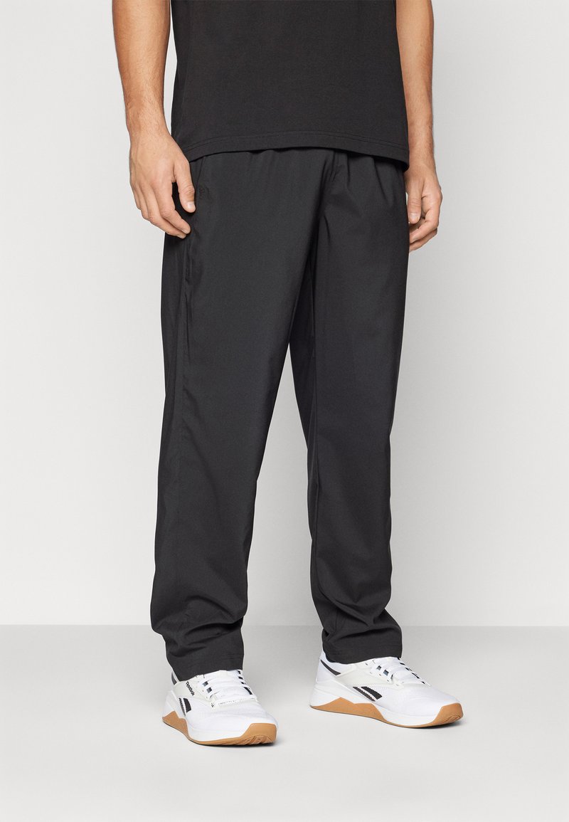 Reebok TRAIN UNLINED PANT - Tracksuit bottoms - black