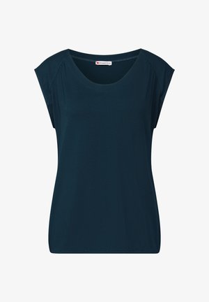 Laituva tummansininen lyhythihainen paita, jossa on pyöreä kaula-aukko ja joka on valmistettu pehmeästä kankaasta. Suunnittelussa on rento ja löysä istuvuus sekä hienovaraiset olkatyynyt.