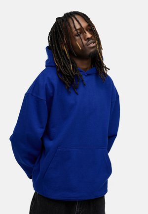Blue hoodie made of sweatshirt fabric, featuring a front pocket, oversized fit, and a drawstring hood. Textured surface and relaxed design.
