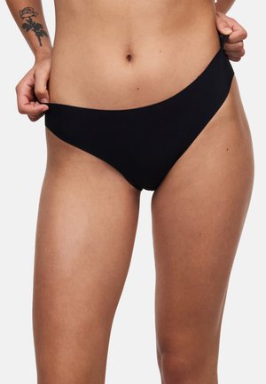 Musta bikinihousu, jossa on sileä, matta viimeistely. Siinä on matala vyötärö ja minimaalinen peittävyys, saumattomilla reunoilla mukavuutta varten.