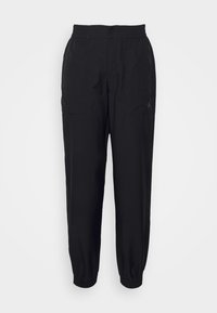 Pantalones deportivos negros con cinturilla elástica, puños ajustados y bolsillos laterales. Presentan un pequeño logo en la pierna izquierda. Textura de tejido suave.