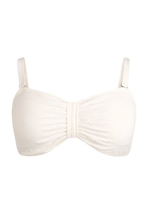 Valkoinen bandeau-tyyppinen rintaliivit, joissa on ohuet säädettävät olkaimet ja hienovarainen kuvioitu kukkakuvio kankaassa.