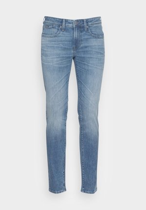 Lichtblauwe denim jeans met een slim fit, voorzien van voorzakken, een knoopsluiting en subtiele vervaging langs de benen voor extra textuur.