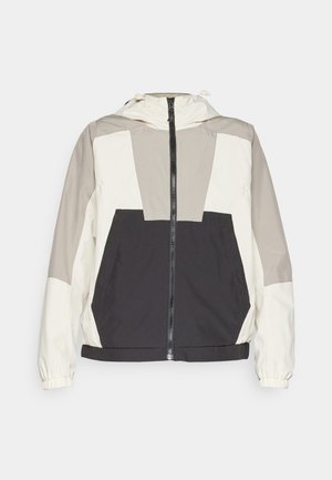 Farbenfester Windbreaker mit einem Design in Beige, Grau und Schwarz, einem vorderen Reißverschluss und elastischen Bündchen. Leichter Stoff mit Kapuze.