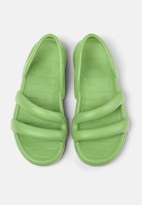 Green plastic sandals featuring a contoured footbed, overlapping strap design, and textured soles for grip. Smooth finish throughout.