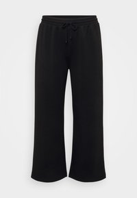 Fekete, bő szabású melegítőnadrág, elasztikus derékrésszel és húzózsinórral, sima textúrával és látható minták vagy kiegészítők nélküli kivitelben.