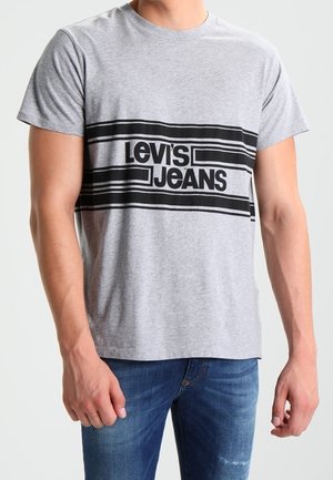 Gray cotton t-shirt featuring a black striped graphic with "LEVI'S JEANS" text across the chest. Short sleeves and a classic crew neck design.