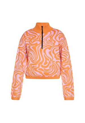 Oranssi ja vaaleanpunainen lyhyt neule korkealla kauluksella, jossa on vetoketjusuljenta ja pyörteinen kuvio design pehmeällä kankaalla.