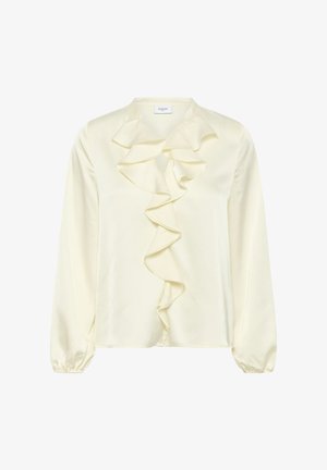 Krém selyemblúz fodros elülső résszel, hosszú ujjakkal, elasztikus mandzsettagal és kerek nyakkivágással. Az anyaga sima és kellemes tapintású.