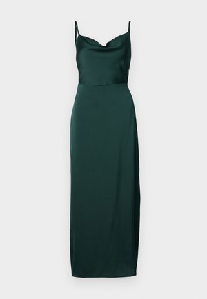 Tume roheline satiinist kleit, millel on kaelanõlv, spagetitraapid ja külgmine lõhik, mis loob voolava silueti. Pikad, voolavad jooned.