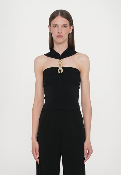 Haut noir sans bretelles avec un design à l'avant torsadé et un ornement en or et cristaux au centre, tissu lisse, silhouette ajustée.